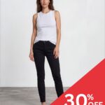 Model wearing a white sleeveless top and black jeans, posing in a studio with a red 30% OFF promotion banner in the corner.