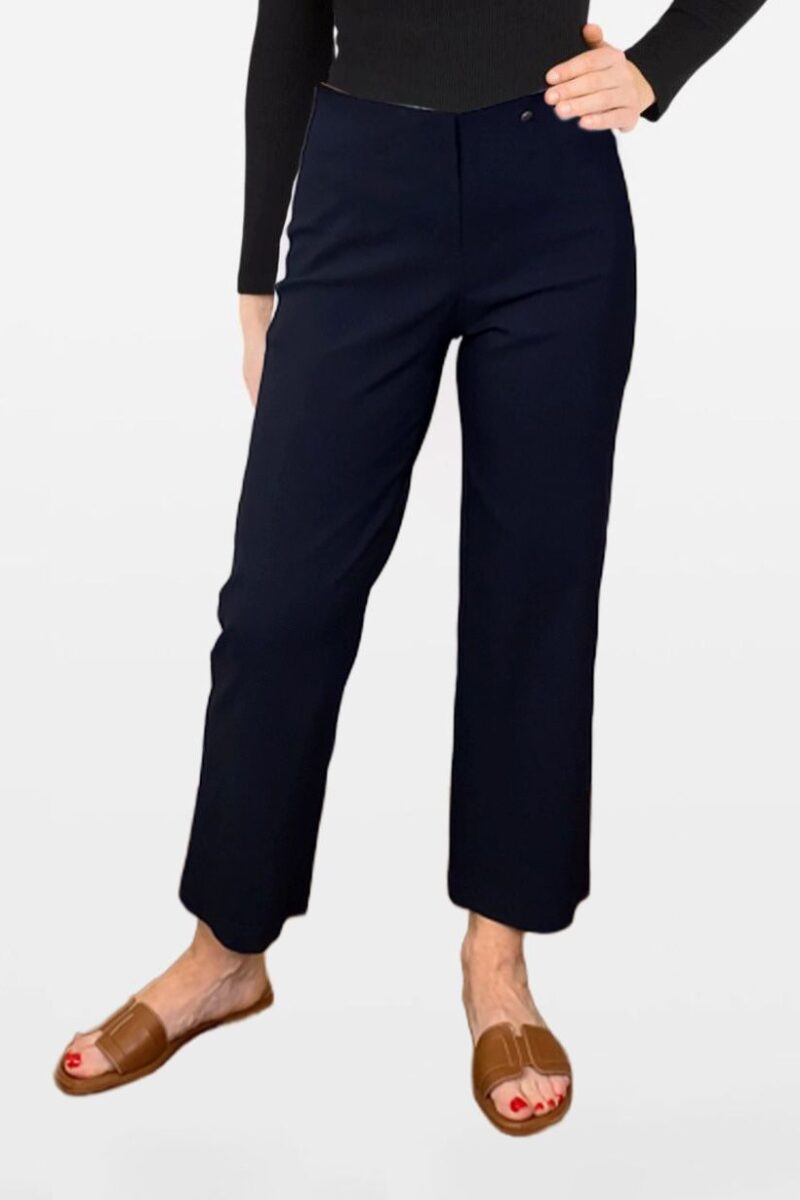 Navy cropped trousers paired with a black top and brown slide sandals.