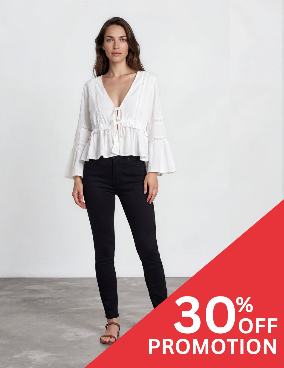 Ami SKinny Black DIS Model wearing a white V-neck peasant blouse and black skinny jeans stands against a plain light background with a red 30% OFF promotion banner in the corner.
