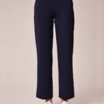 Navy blue straight-leg pants cropped at the ankle, paired with white sneakers on a neutral backdrop.