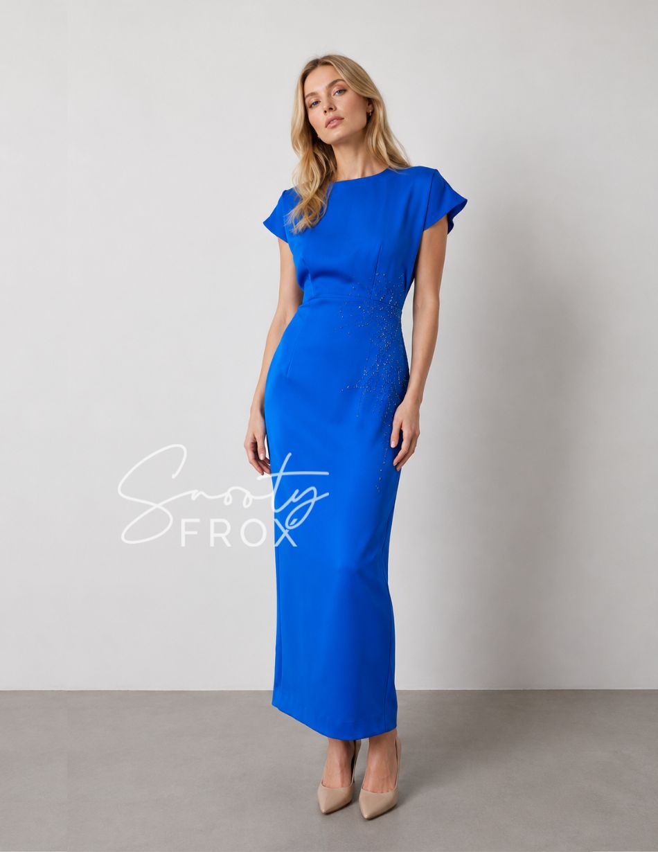 Full-length royal blue evening gown with cap sleeves and beaded waist on a model wearing beige pumps.