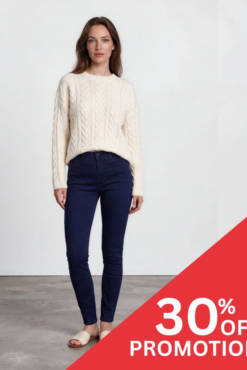 Woman in a cream cable-knit sweater and navy jeans, standing with a diagonal red 30% OFF promotion banner in the bottom right corner.