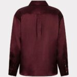 Back view of a burgundy satin button-up shirt with a center back pleat and long sleeves.