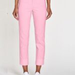 Light pink cropped trousers with wide cuffs worn by a model paired with white sneakers, full-length view.